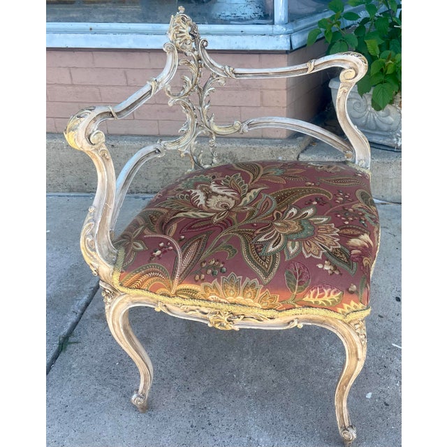 What a sweet, delicate, carved, petite Louis XV corner chair which has been painted in antique white with gold highlights...