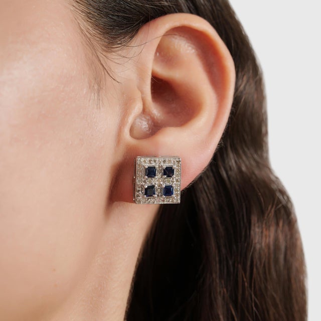 These Art Deco-inspired square halo earrings feature 1.60 carats of deep blue square-cut sapphires framed by 0.73 carats...