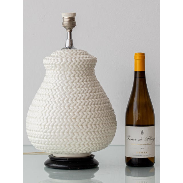 Vintage trompe-l’œil wicker basketweave table lamp in glazed white ceramic made in the historic ceramics center of...