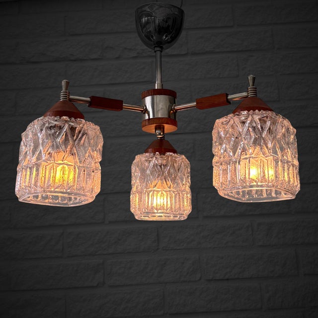 Scandinavian ceiling lamp with three arms, produced by an unidentified Swedish manufacturer in the 1950s. Executed in a...