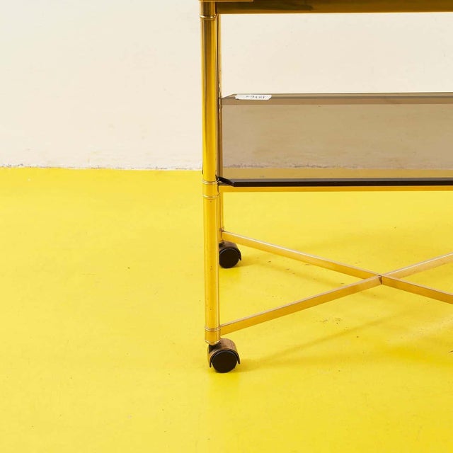 Discover the elegance and functionality of this coffee table, a true design object. With a gold-plated metal frame and...