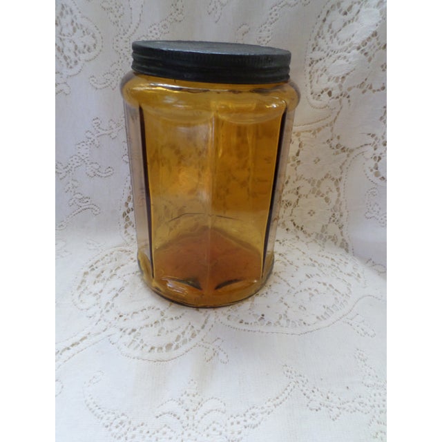 This is a Antique 1910 Amber Glass Octagon Shape Hoosier Cabinet Jar With Lid with a Deep Amber Color with Tin Screw Cap...