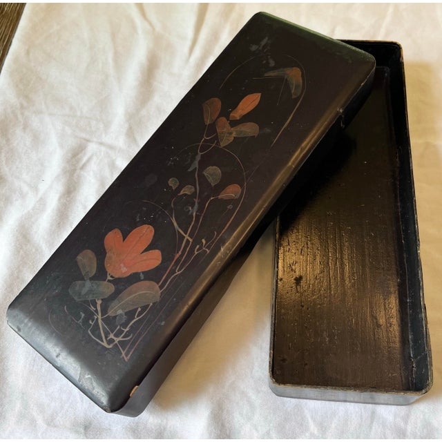 Gorgeous antique Japanese lacquerware glove box depicting a hand painted botanical scene. The box is long and light weight...