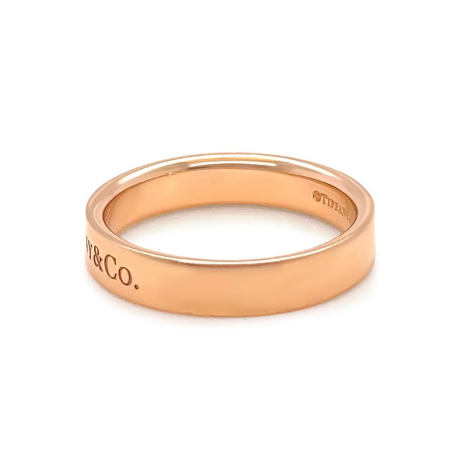 A timeless Tiffany & Co. flat band ring crafted in 18ct yellow gold, featuring a clean 4mm profile that embodies the...