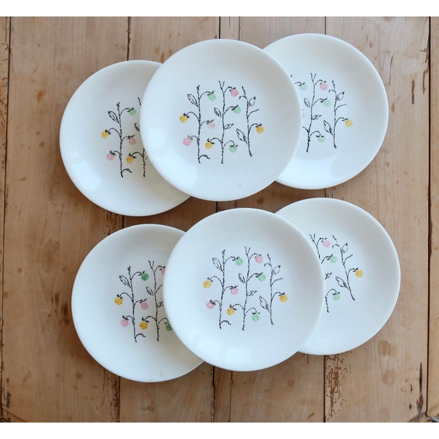 Marie-Claire pattern dinner plates, recognizable by their delicate design of small pastel flowers on slender black stems....