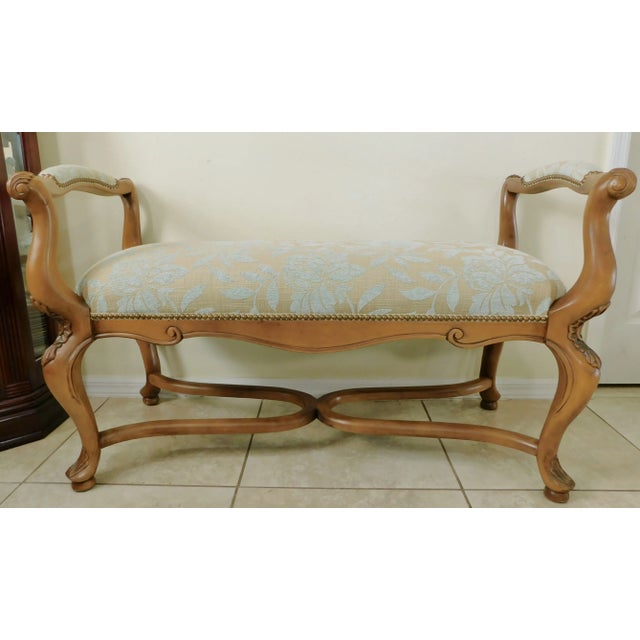 Beautiful late 20th century light blue and beige upholstered, brass studded, carved wood bench. Well made , nice quality...
