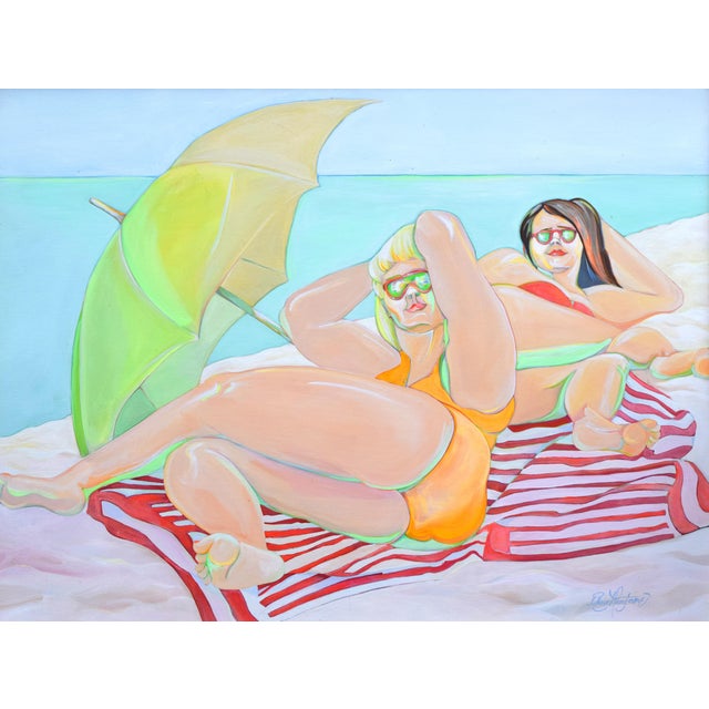 Large painting of two sun bathers under an umbrella at the beach. Oil on canvas presented in a light wood frame. Signed...