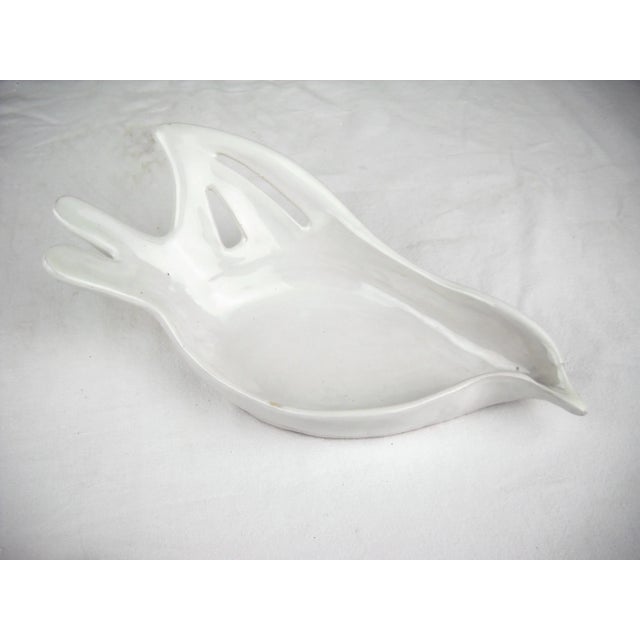 Vintage hand-crafted ceramic dish of a contemporary-styled dove in flight. Vessel is crafted of ceramic with a white...