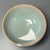 Classic Chinese celadon bowl with elegant rounded shape, finished in soft pale‑blue‑green glaze covered with fine natural...