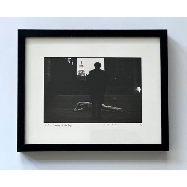 An editioned gelatin silver print by American photographer Duane Michals (1932-). Entitled "A Man Dreaming in the City",...