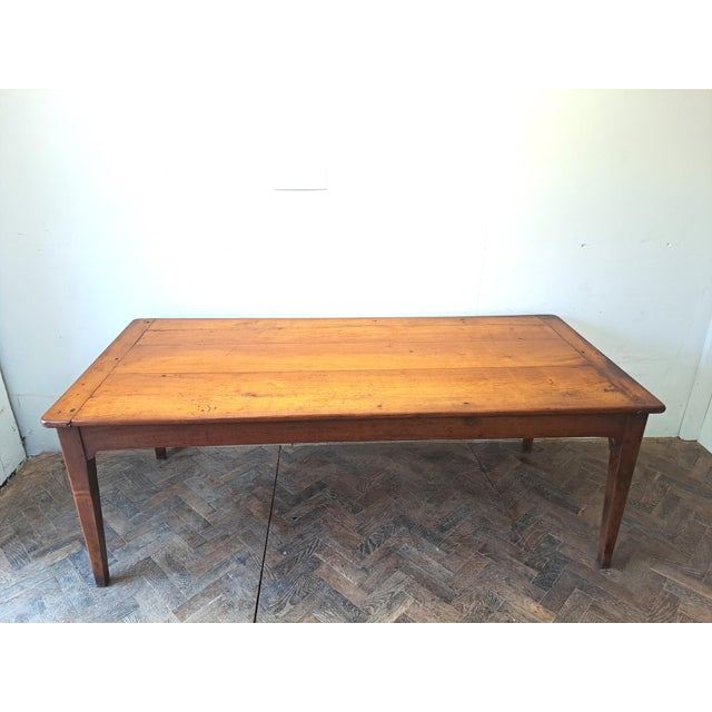 A fine mid-19th century French cherrywood farmhouse kitchen table of particularly good form and proportions. The top is...