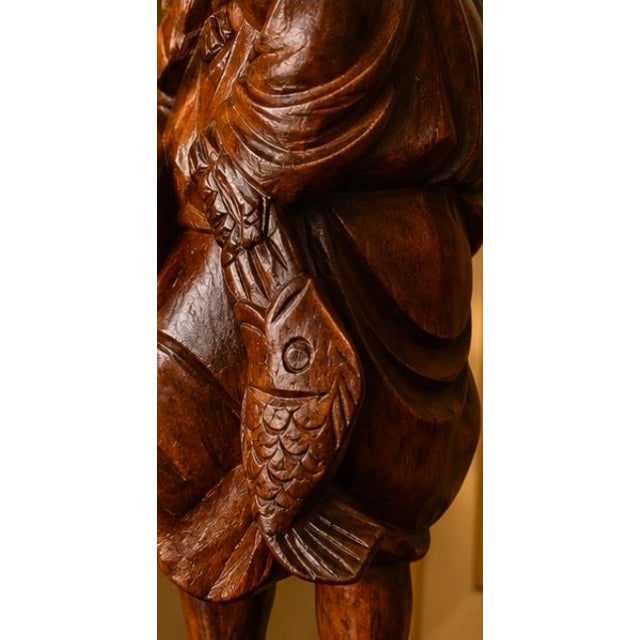 Beautiful hand carved vintage Chinese fisherman. Stunning natural wood shows off the intricate detailing of the carved...