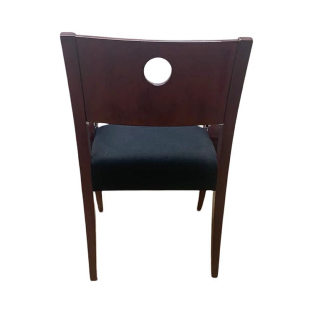 This Kensington chair by Brueton has a black seat and a solid maple frame stained in a sienna brown. The frame is double...