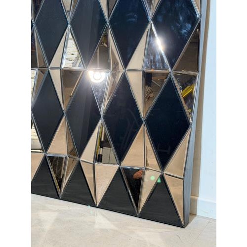 Striking large wall mirror composed of sculptural faceted mirror panels arranged in a geometric grid. Each mirrored...