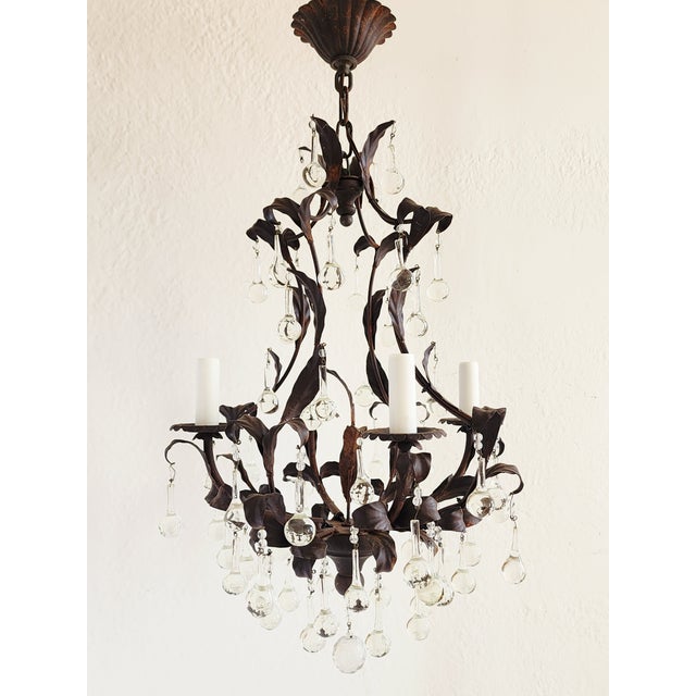 Offering a very pretty French 19th Century style wrought iron and tole birdcage chandelier with 4 lights. Featuring a rust...