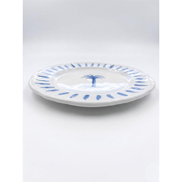 This charming ceramic dinner plate by Les-Ottomans captures a sophisticated yet relaxed coastal aesthetic. Hand-painted in...