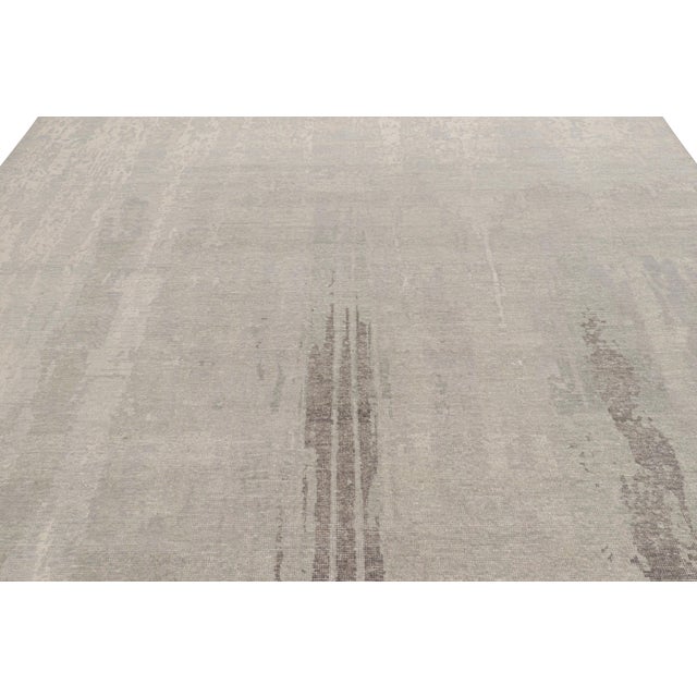 Hand-knotted in wool, this 9x12 modern rug, originating from India, as inspired by modern art with an abstract pattern, is...