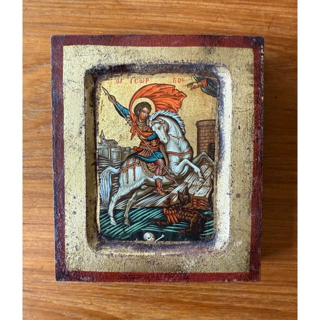 Traditional Byzantine hand painted on wood of the Orthodox icon depicting Saint George and the Dragon. Crafted in the...