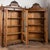 Pair of late 19th century display cabinets, crafted in walnut and veneer with pine interiors. Each cabinet is topped by a...