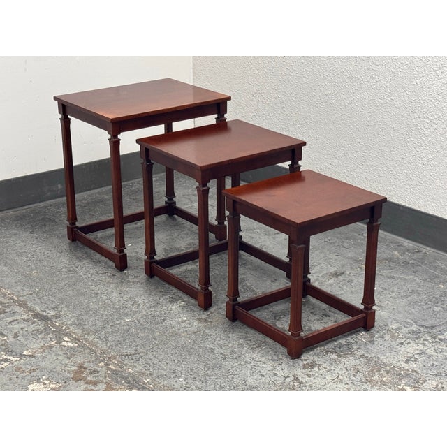 Design Plus Gallery presents a Set of Three Traditional Wood Nesting Tables. Each table has a rectangular wood top...