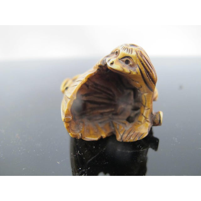 Japanese finely carved bone Netsuke figurine, most likely early 19th century, signed at base. In form of Nappa, the water...