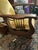 A Morris-style rocking chair with a dark wood frame, slatted sides, a pull-out footrest and gold velvet cushions. Details:...