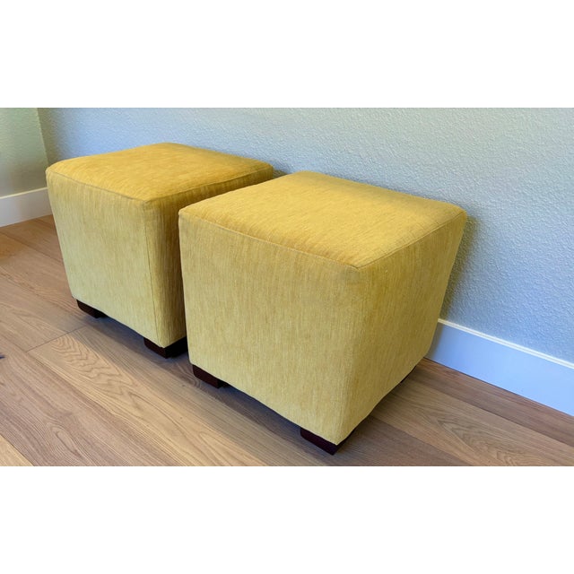 These ottomans are upholstered with a wonderfully soft chenille in a mustard color and have unusual square bun feet. With...