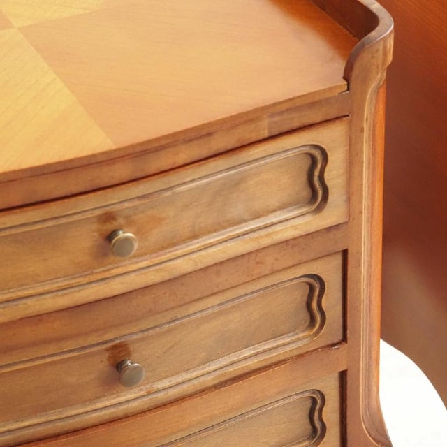 An elegant pair of French bedside tables (chevets) from the Louis-Philippe period, each with three paneled drawers and...