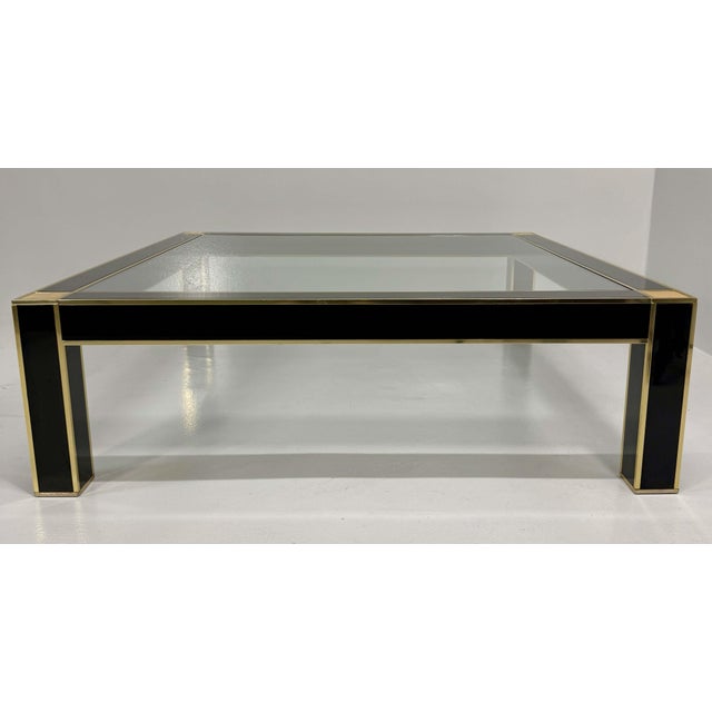 Elegant square coffee table attributed to Pierre Cardin, produced in France during the 1970s. The table perfectly embodies...
