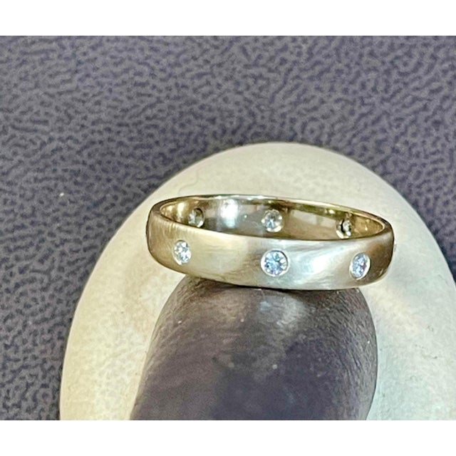 8 Flush Set Bezel Diamond Eternity Wedding Band in 14 Karat Yellow Gold Size 11 All 8 diamonds are scattered uniformly all...
