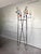 An iconic example of French Mid-Century design, featuring a black lacquered steel wire structure adorned with brightly...