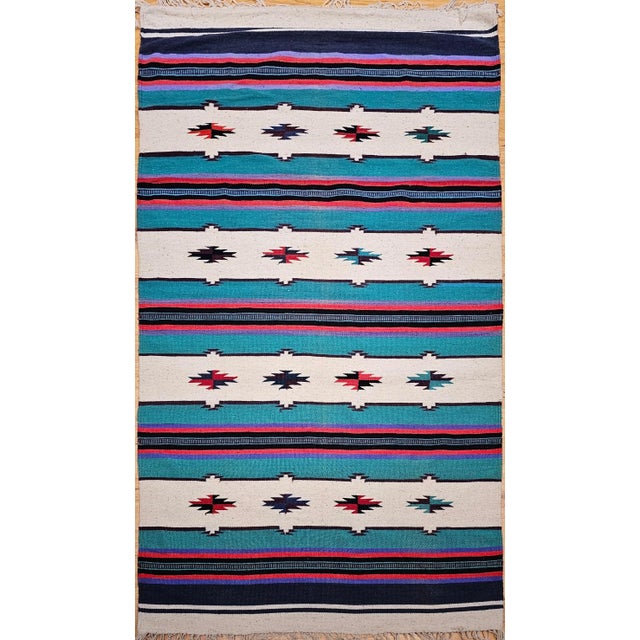 This vintage Southwestern kilim rug, part of our curated Americana Collection, features a bold and balanced design with...