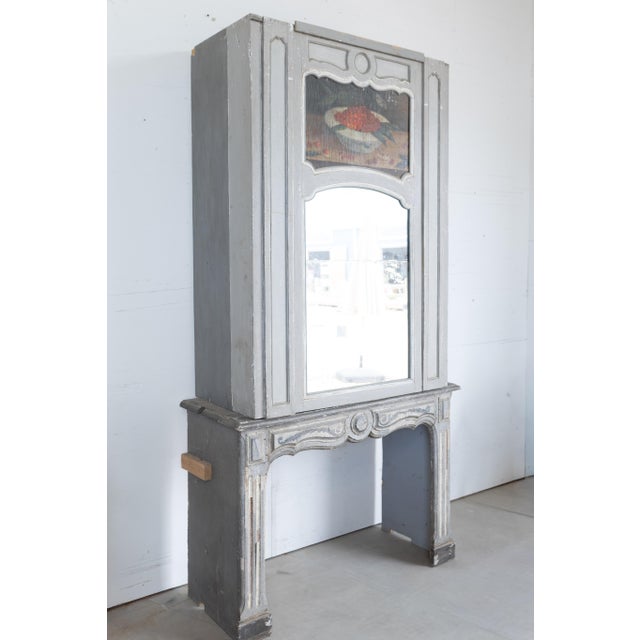 A striking and highly decorative 18th century French fireplace mantel, beautifully reimagined as a statement architectural...