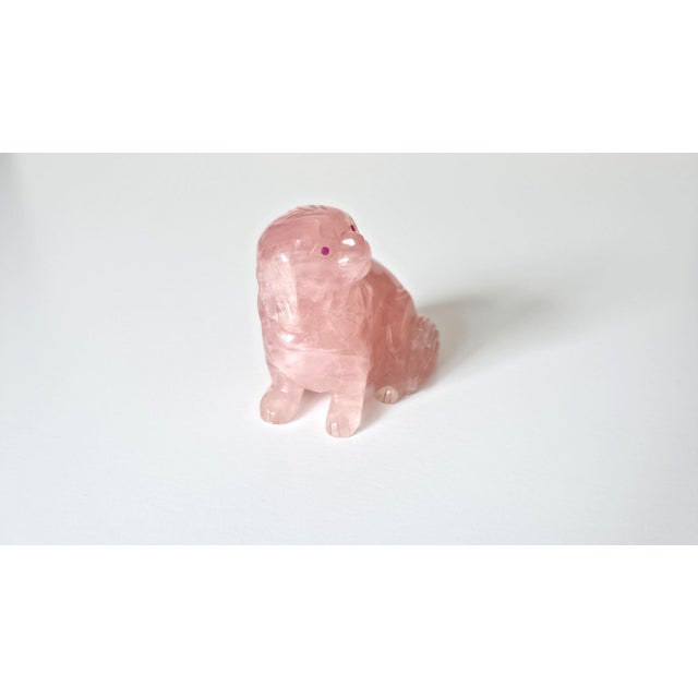 A charming and finely carved rose quartz dog, accented with vivid ruby eyes. This delightful sculpture is believed to...