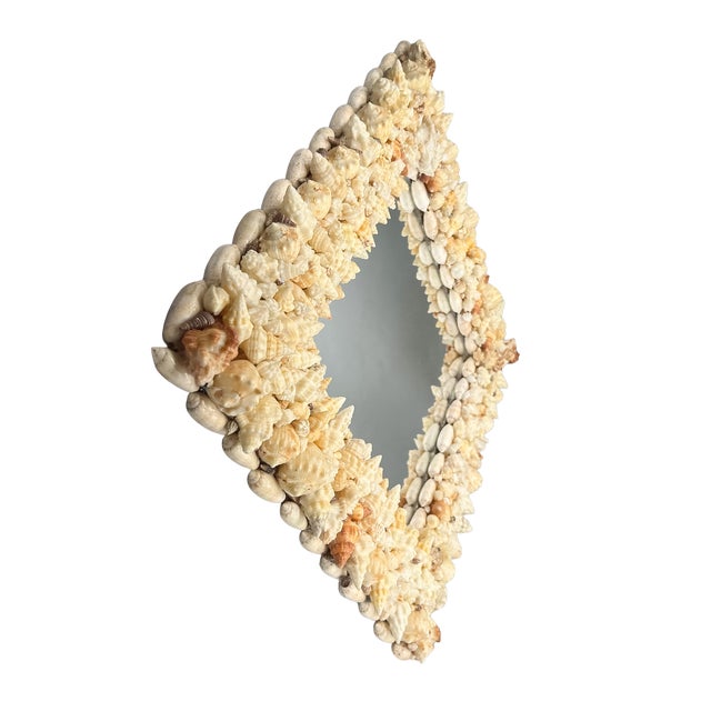 One-of-a-kind vintage wall mirror featuring a dramatic diamond-shaped frame densely embellished with an assortment of...