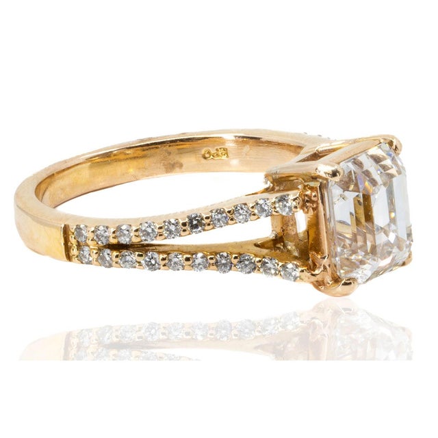 18k Rose Gold ring with one 2.02 carat GIA certified (# 5211345626) K color VS2 clarity emerald cut diamond and 40 round...