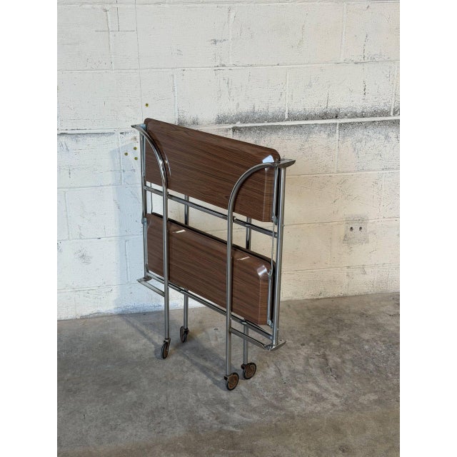 This space-saving rolling bar cart features a tubular frame supporting two tiers of trays for entertaining. Its smooth...