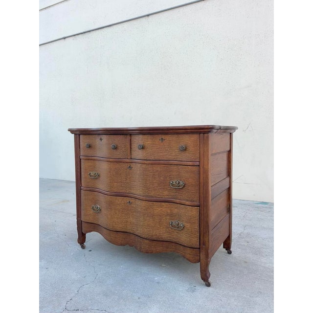 Beautiful antique oak dresser / chest of drawers with an elegant French Provincial-inspired silhouette and wonderfully...
