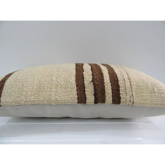 This is a pillow cover made from a vintage kilim rug. The piece was properly washed and ready to use. Pillow inserts not...