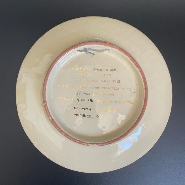 A vintage 70s "Mother's Day" Italian art pottery decorative wall plate by Vincente Tiziano. The portrait depicts a tender...