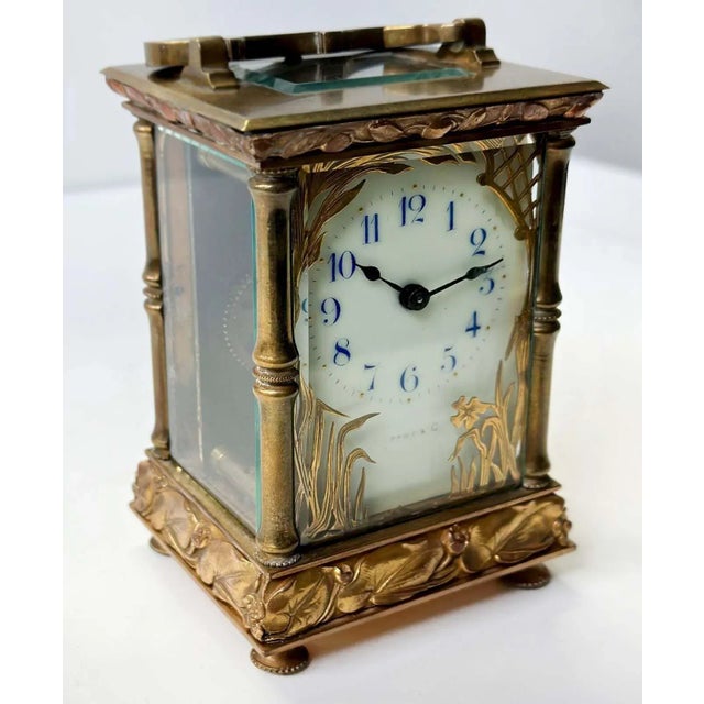 Lovely brass and glass carriage clock by C.R. Crookshank for Tiffany & Co. Made in France in the 20th century. Adorned...