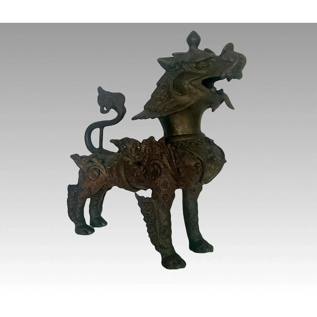 Highly ornate antique bronze Buddhist lion sculpture from Nepal. Lost wax bronze lions cast in two sections, forelegs, and...