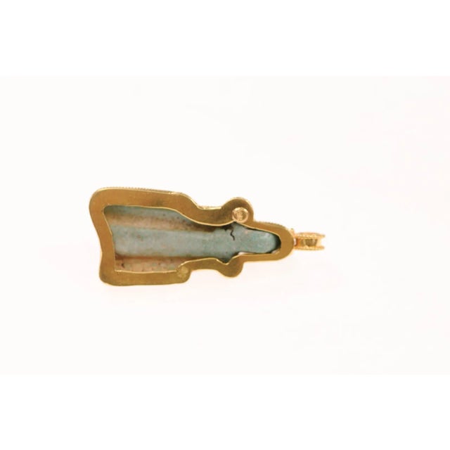 An Egyptian Faience Cat Pendant trimmed skillfully w 21K gold. This fabulous fragment is trimmed in 21 karat gold and...