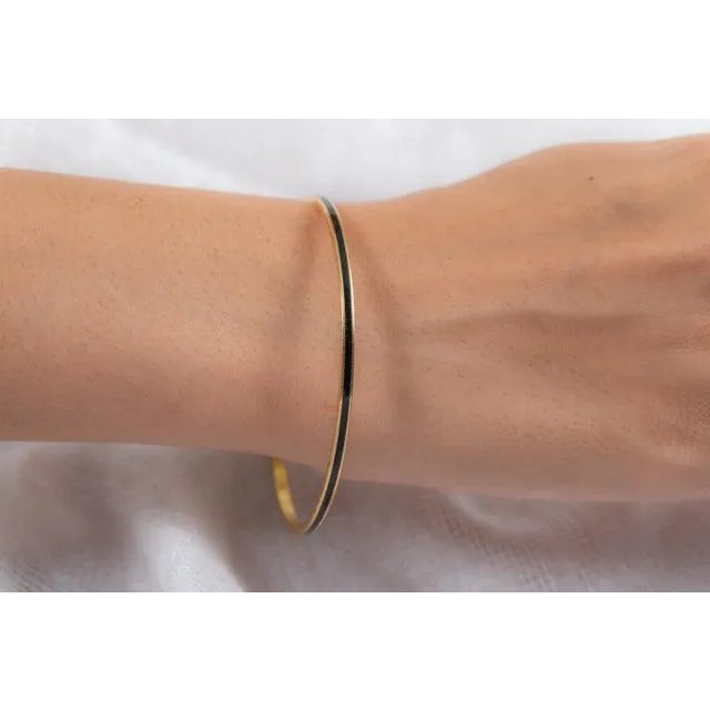 This is part of Chairish’s Fine Jewelry assortment. Black Enamel Bangle in 18K Gold. It’s a great jewelry ornament to wear...