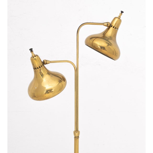 Mid-Century Modern Brass Two-Branch Arc Floor Lamp, the stem above a circular base. 59" H x 22" W x 10" D. Provenance:...