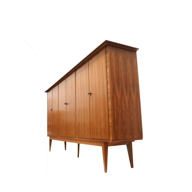 XXL Vintage highboard / tall sideboard made in the 1970s. Large vintage highboard from the 1970s with a sleek design and...
