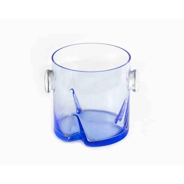 Glass ice bucket is a vintage decorative object realized in the 1970s. Original Art blue glass. Made in Italy. Dimensions:...