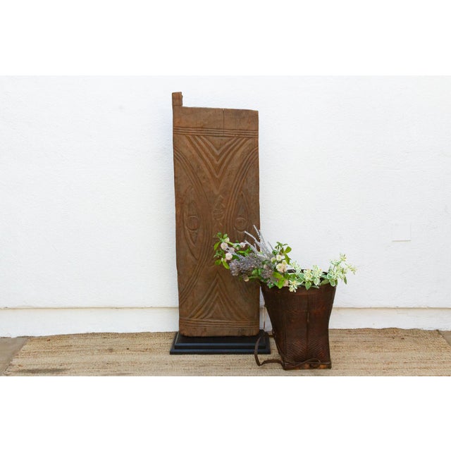 From the Bandiagara escarpment region of Mali, this monolithic single-plank granary or shrine door is carved with a...