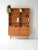 1960s bookcase with open shelves, drawers, and a storage compartment. Linear structure and light proportions typical of...