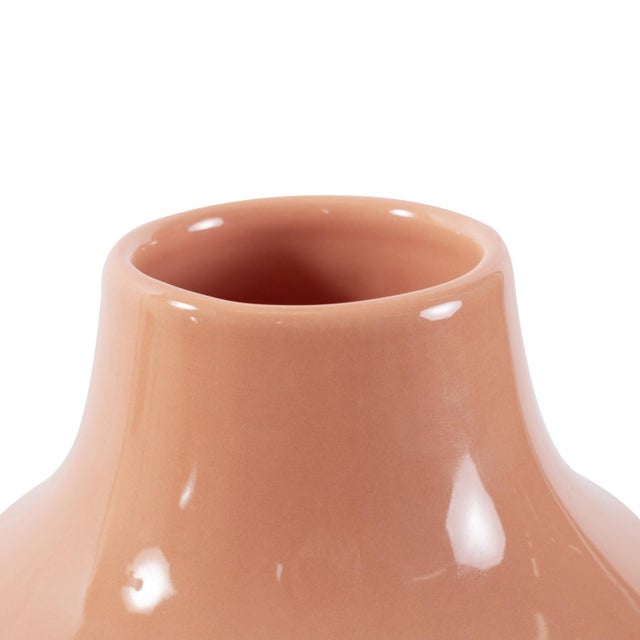 This peach ceramic vase featuring a captivating blend of glossy and matte finishes, is available in three sizes. The...